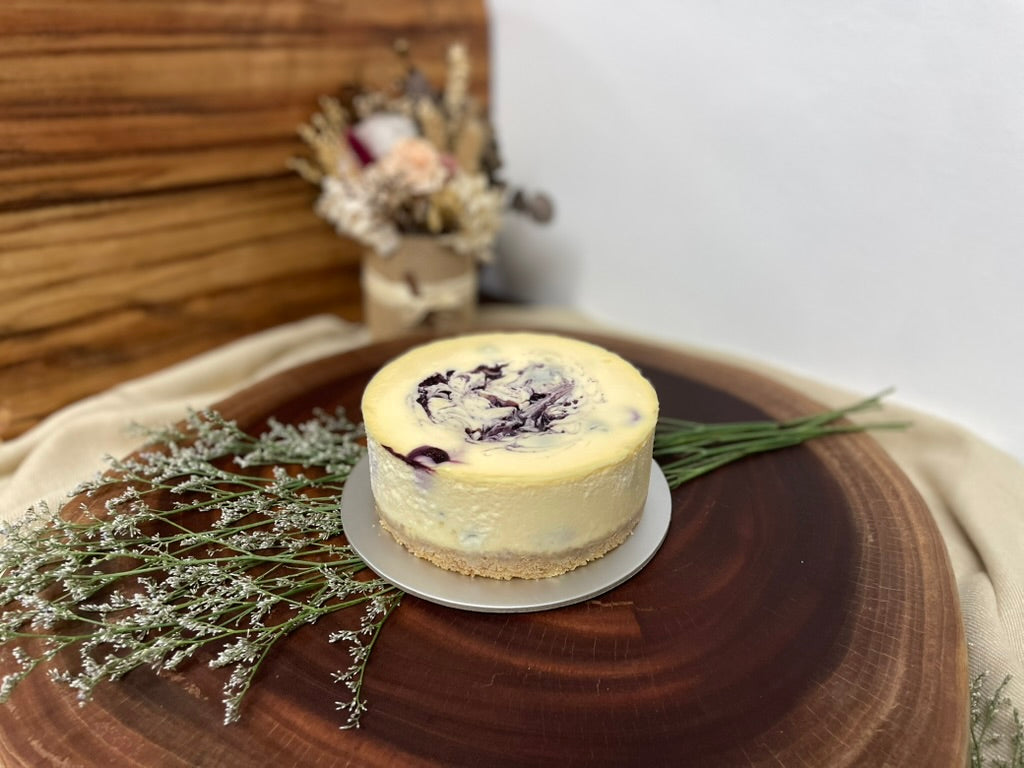Small cheesecake on a wooden board with decorative elements